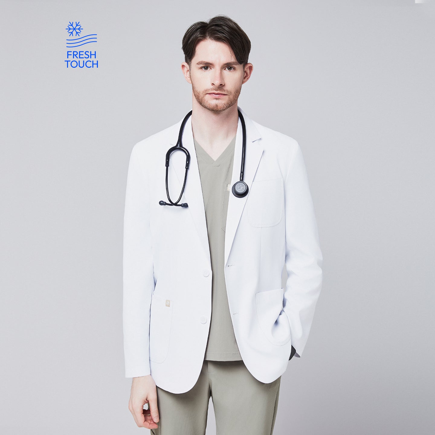 Image of Front view of a male model wearing a white short lab coat over olive green scrub pants, showcasing clean and tailored design,White